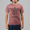 A MYSTERIOUS BEARDED MAN WALKS INTO A ROOM TSHIRT IN MAUVE MIXED ETHNICITY MAN STANDING.